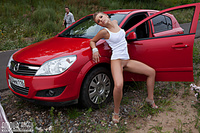 Erotica younger posing near car