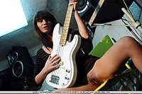 Ultra seductive brunette baring her large breasts and untrimmed bush with an electric guitar.